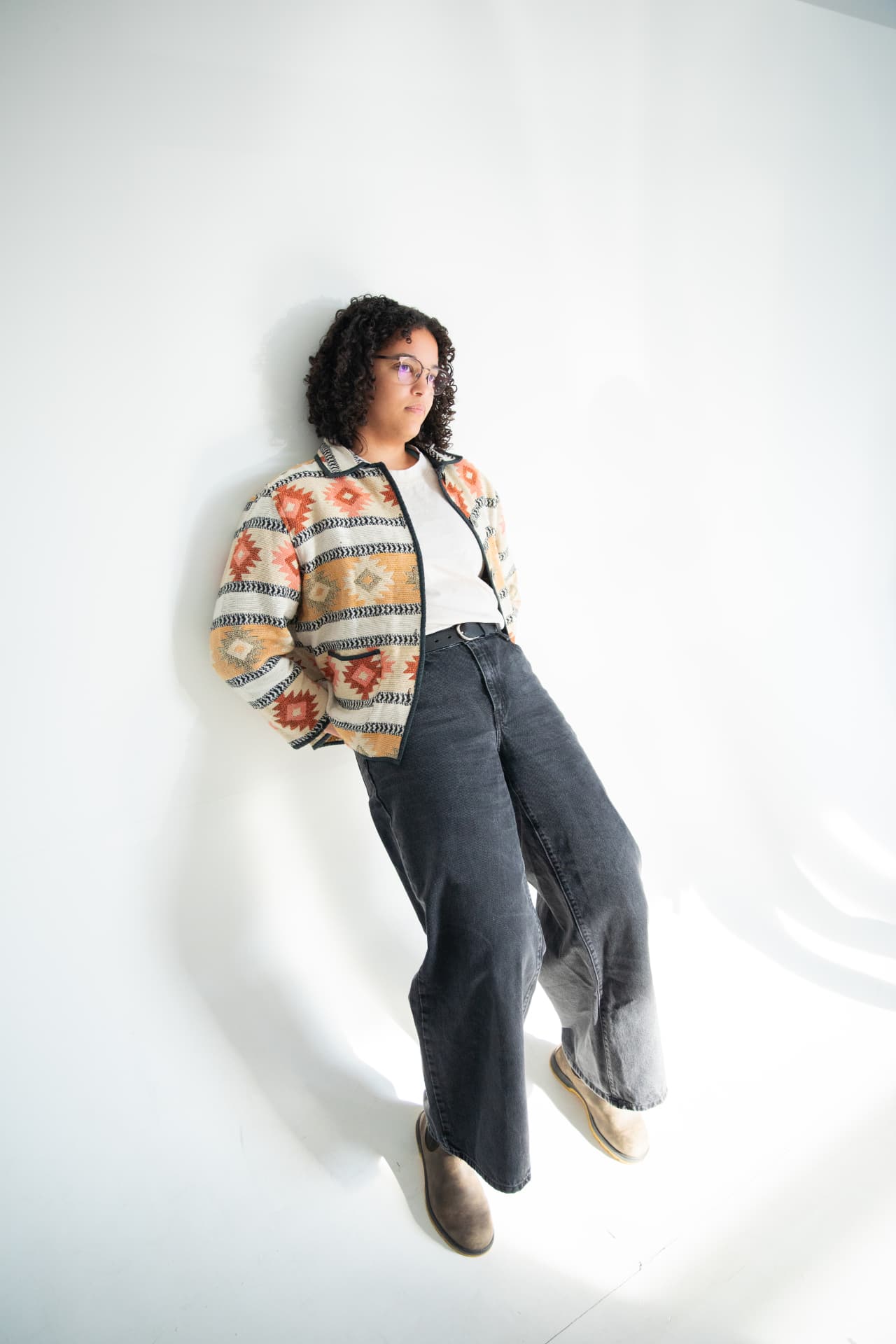 Patterned jacket and wide-leg jeans styled in her palette