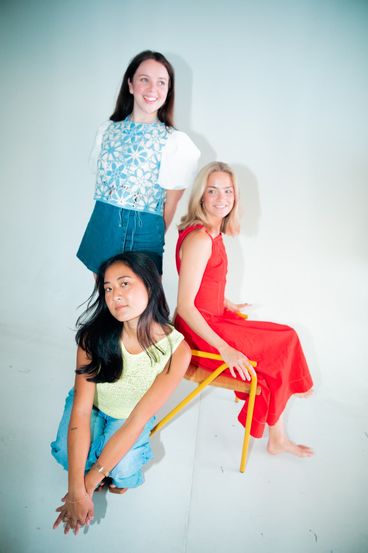 Three women in their colors: blue eyelet, butter yellow and red